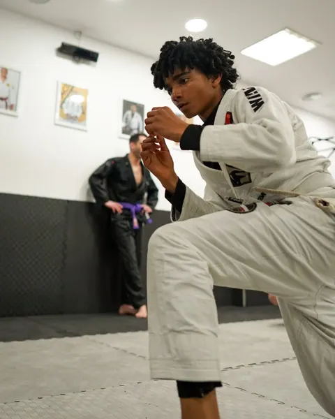 An athlete in a white gi during a drill