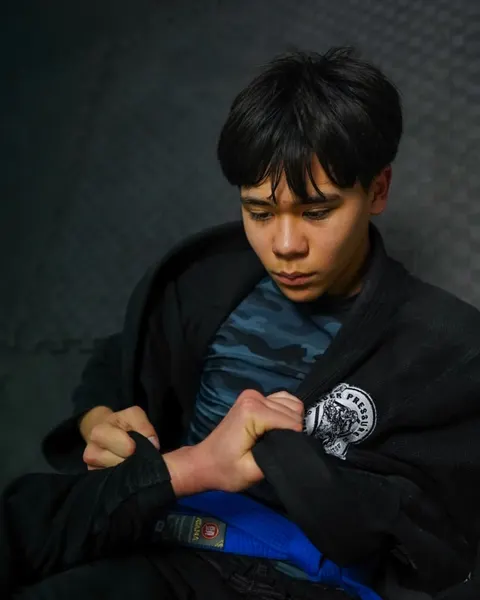 A young athlete adjusting his gi