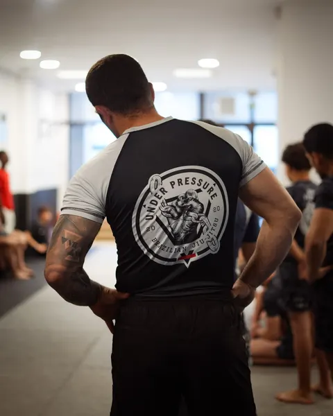 A student in an Under Pressure rashguard, from behind